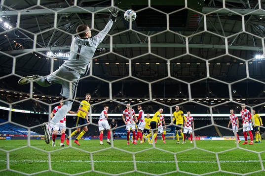 Goalkeeper Dominik Livakovic of Croatia saves the ball