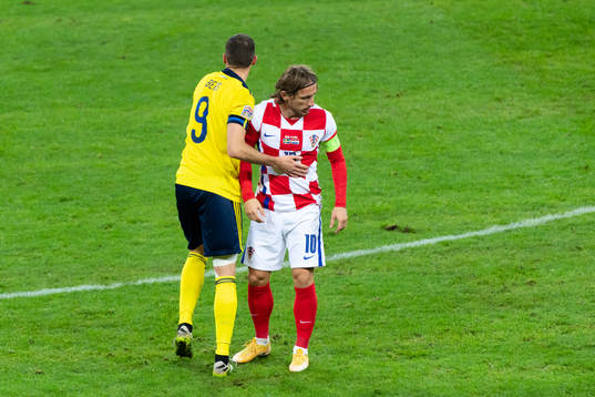 Marcus Berg of Sweden and Luka Modric of Croatia