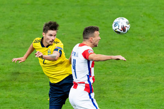 Mikael Lustig of Sweden and Ivan Perisic of Croatia