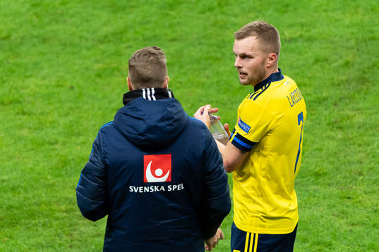 Sebastian Larsson of Sweden talks to head coach Peter