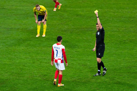 Josip Brekalo of Croatia is shown a yellow card by referee