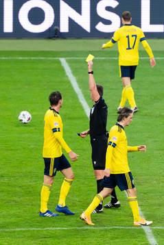 Albin Ekdal of Sweden is show a yellow card
