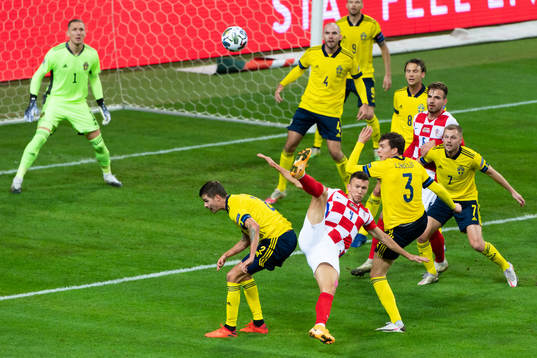 Mikael Lustig of Sweden and Ivan Perisic of Croatia