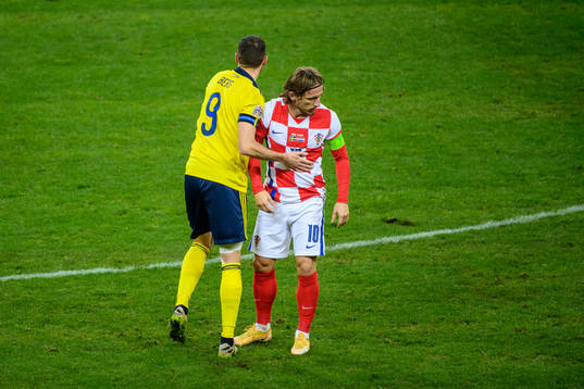 Marcus Berg of Sweden and Luka Modric of Croatia