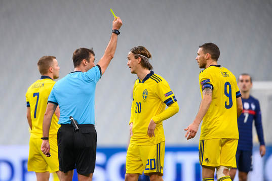 Kristoffer Olsson of Sweden receives a yellow card