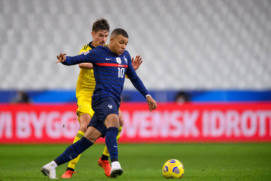 Mikael Lustig of Sweden and Kylian Mbappé of France