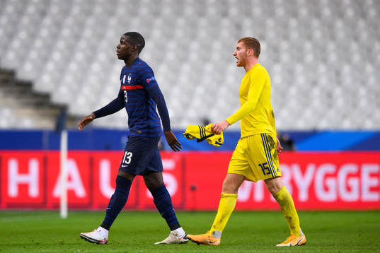 Kurt Zouma of France and Dejan Kulusevski of Sweden look