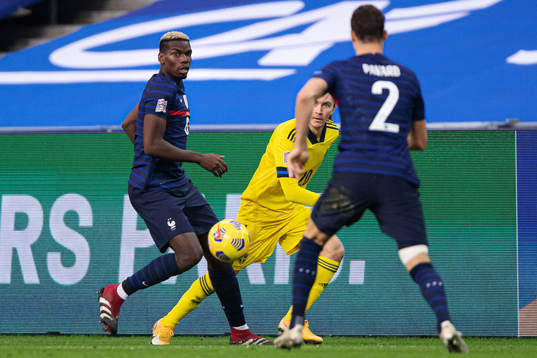 Paul Pogba and Benjamin Pavard of France against Kristoffer