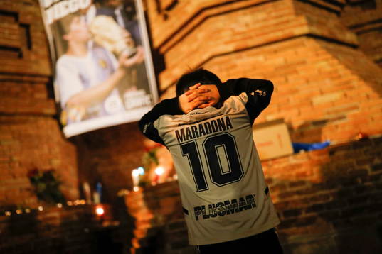 A fan gestures as he pays tribute to late Argentine soccer