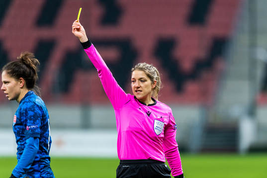 Referee Karoline Wacker awards a yellow card