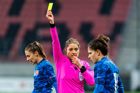 Referee Karoline Wacker awards a yellow card