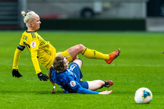 Caroline Seger of Sweden is tackled by Laura Žemberyová