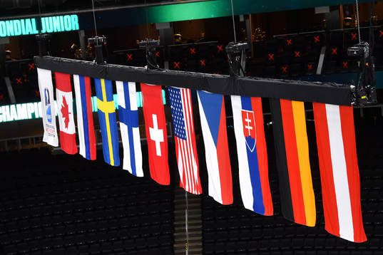 Flags of the participating nations hang above the ice
