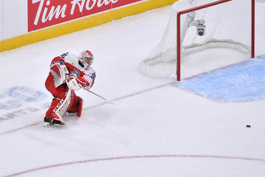 Nick Malik clears the puck
