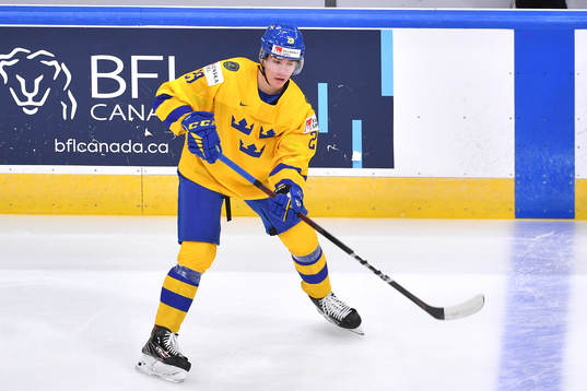 Albin Sundsvik of Sweden passes the puck