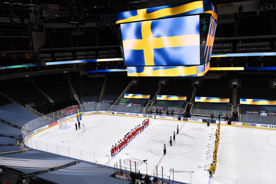 Team Sweden watches the flag being raised