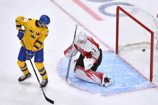Elmer Söderblom of Sweden watches the puck enter the net