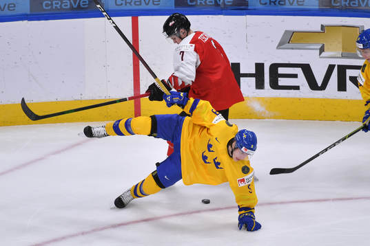 Albert Johansson of Sweden falls to the ice
