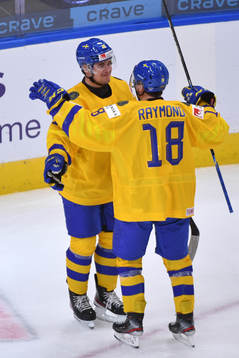 Lucas Raymond and Alexander Holtz of Sweden celebrate the