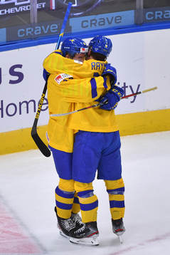 Lucas Raymond and Alexander Holtz of Sweden celebrate the