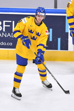 Albert Johansson of Sweden passes the puck