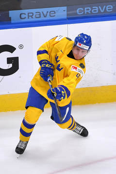 Emil Andrae of Sweden passes the puck