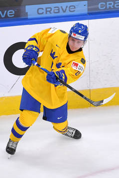 Emil Andrae of Sweden passes the puck