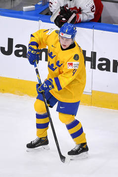 Emil Andrae of Sweden passes the puck