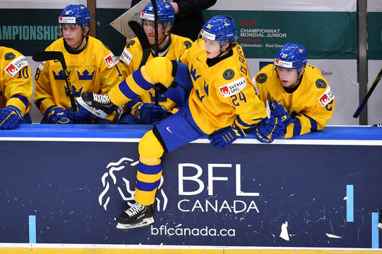 Oskar Olausson of Sweden jumps over the boards