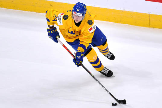 Oskar Olausson of Sweden skates with the puck