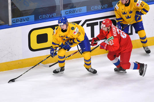 Alex Brännstam of Sweden shields the puck from Marat