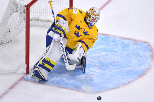 Jesper Wallstedt of Sweden clears the puck