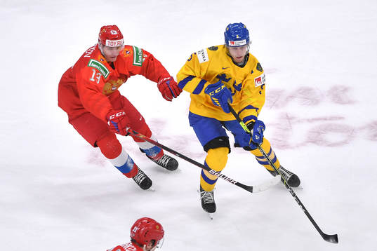 Philip Broberg of Sweden guards the puck from Vasili