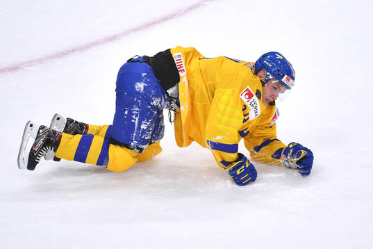 Arvid Costmar of Sweden falls to the ice