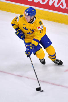 Simon Holmström of Sweden skates with the puck