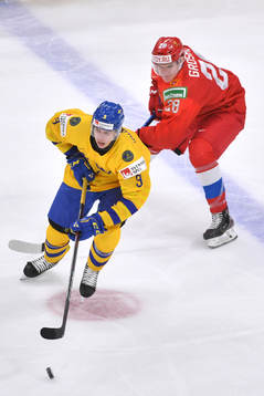 Albert Johansson of Sweden skates away from Maxim Groshev