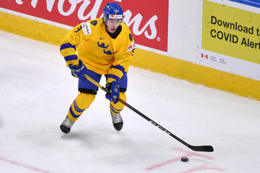 Albert Johansson of Sweden skates with the puck