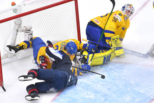 Alex Turcotte of USA and Tobias Björnfot of Sweden collide