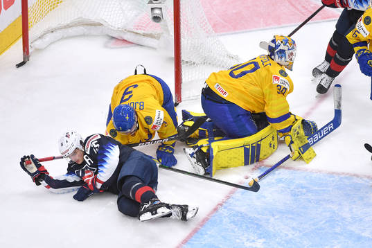 Alex Turcotte of USA and Tobias Björnfot of Sweden collide