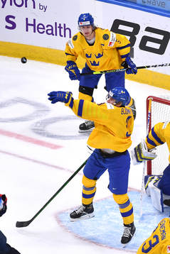 Tobias Björnfot of Sweden bats the puck away from the