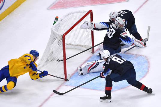 Elmer Söderblom of Sweden tries a wraparound while Spencer