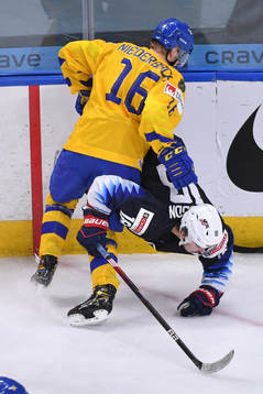 Brendan Brisson of USA falls to the ice