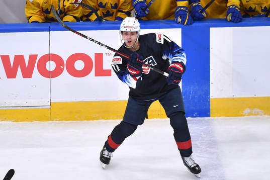 Brock Faber of USA passes the puck