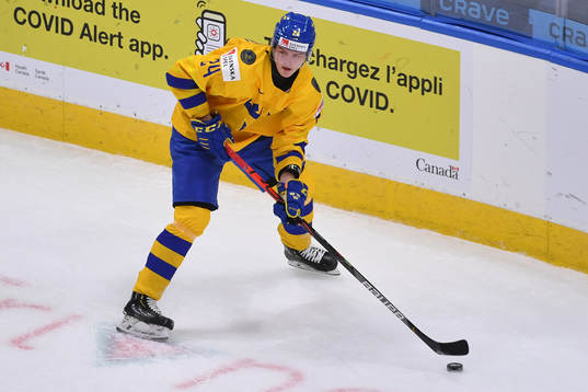 Oskar Olausson of Sweden skates with the puck
