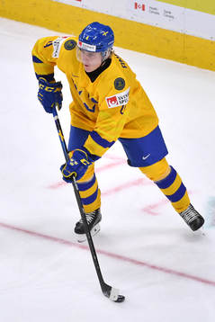 Emil Andrae of Sweden skates with the puck
