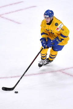 Ludvig Hedström of Sweden skates with the puck