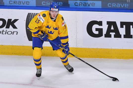 Simon Holmström of Sweden skates with the puck