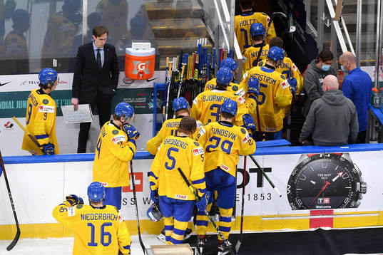Team Sweden players leave the ice in disappointment