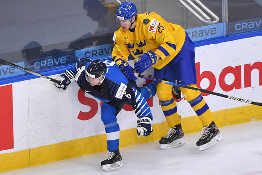 Elmer Söderblom of Sweden hits Eemil Viro of Finland