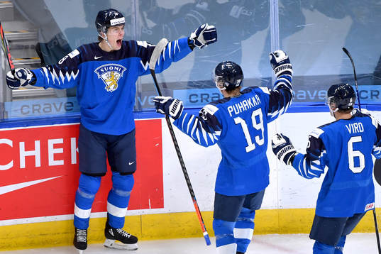 Henri Nikkanen of Finland celebrates with teammates Petteri